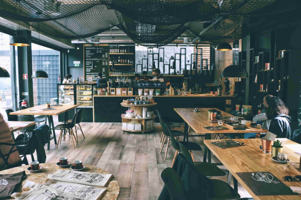 A cozy restaurant featuring wooden tables and chairs arranged for dining